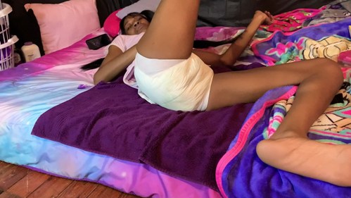 Ebony Girl wetting white diaper.