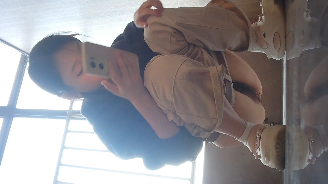 Chinese Girl in Beige Pants Squats and Pees